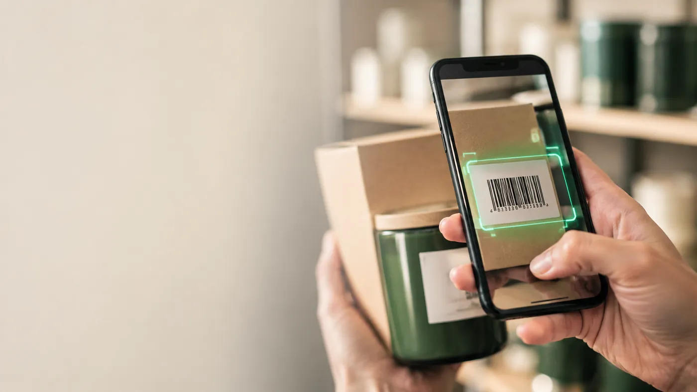 Scanning a product barcode with a phone in a shop stockroom